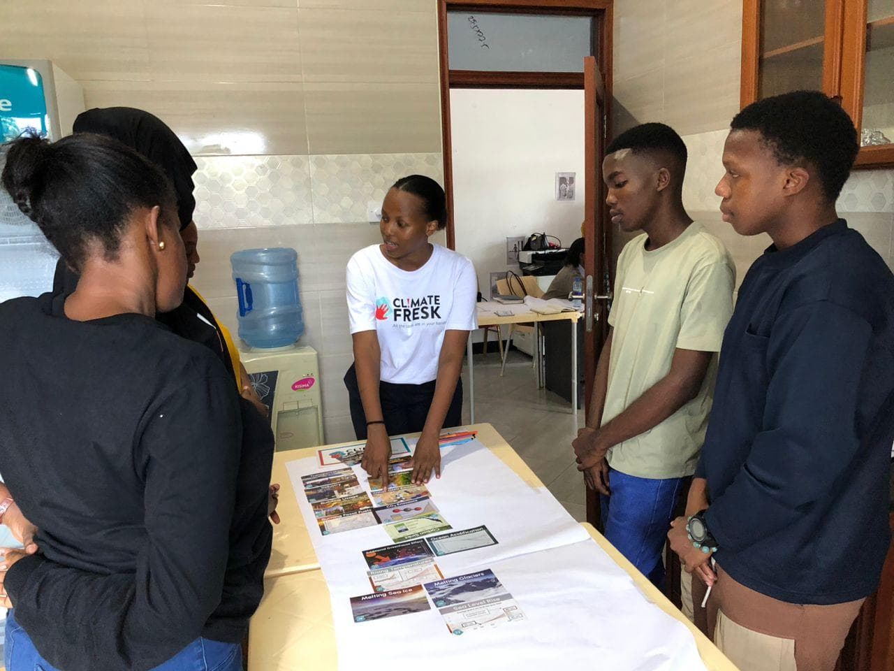 Participants exchanging ideas around a table of climate cards.