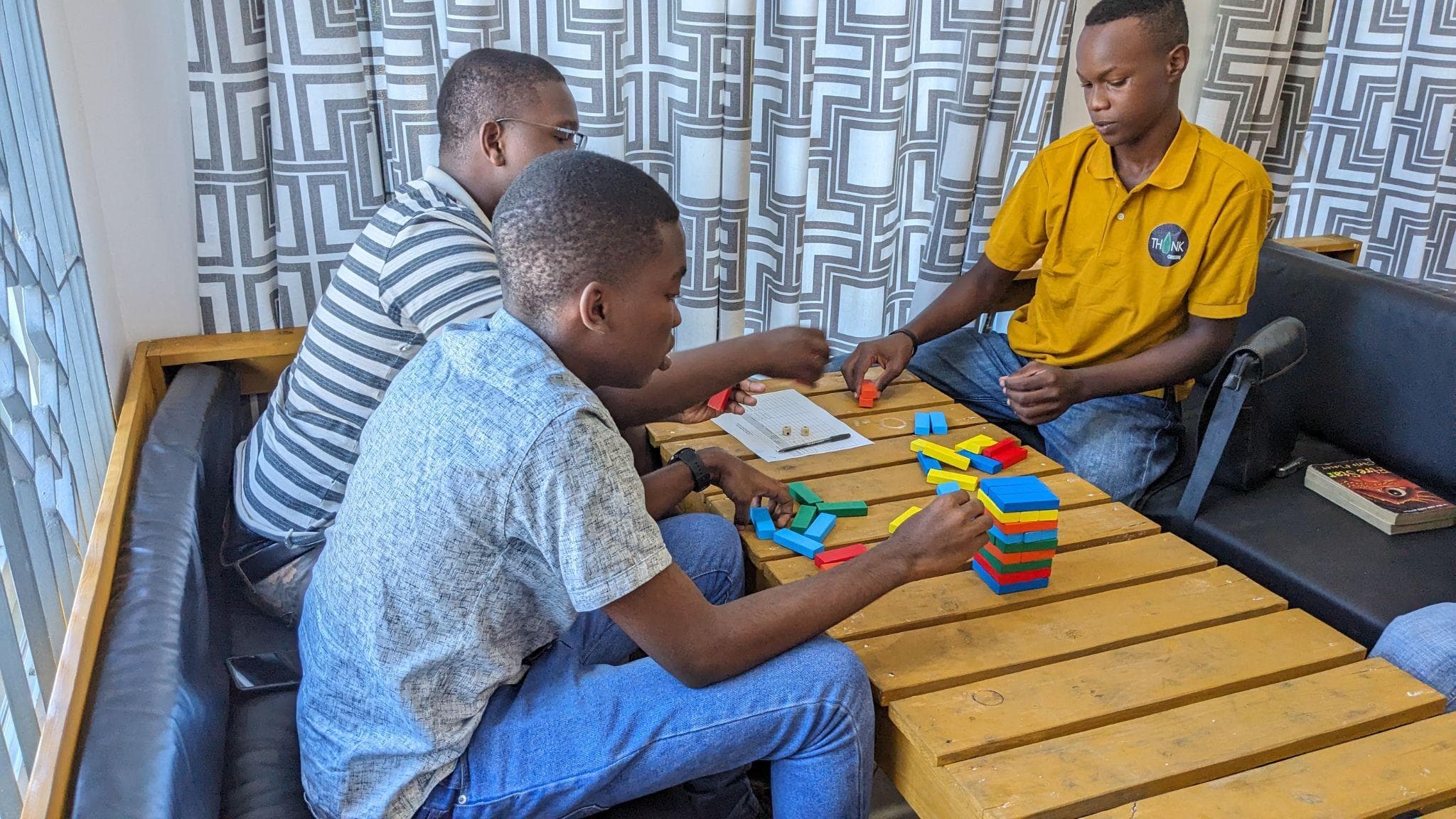 Young participants working together with colorful blocks during an icebreaker.