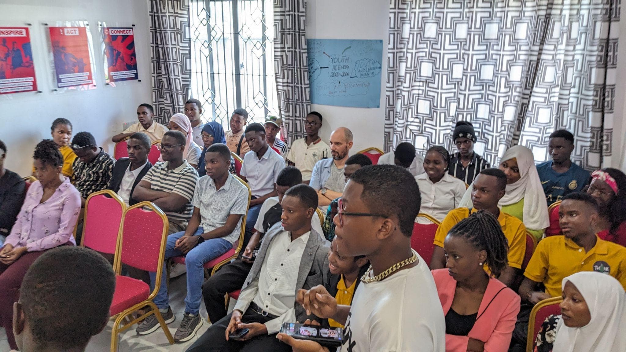 An audience seated in rows during the Eco-Leaders Rise event.