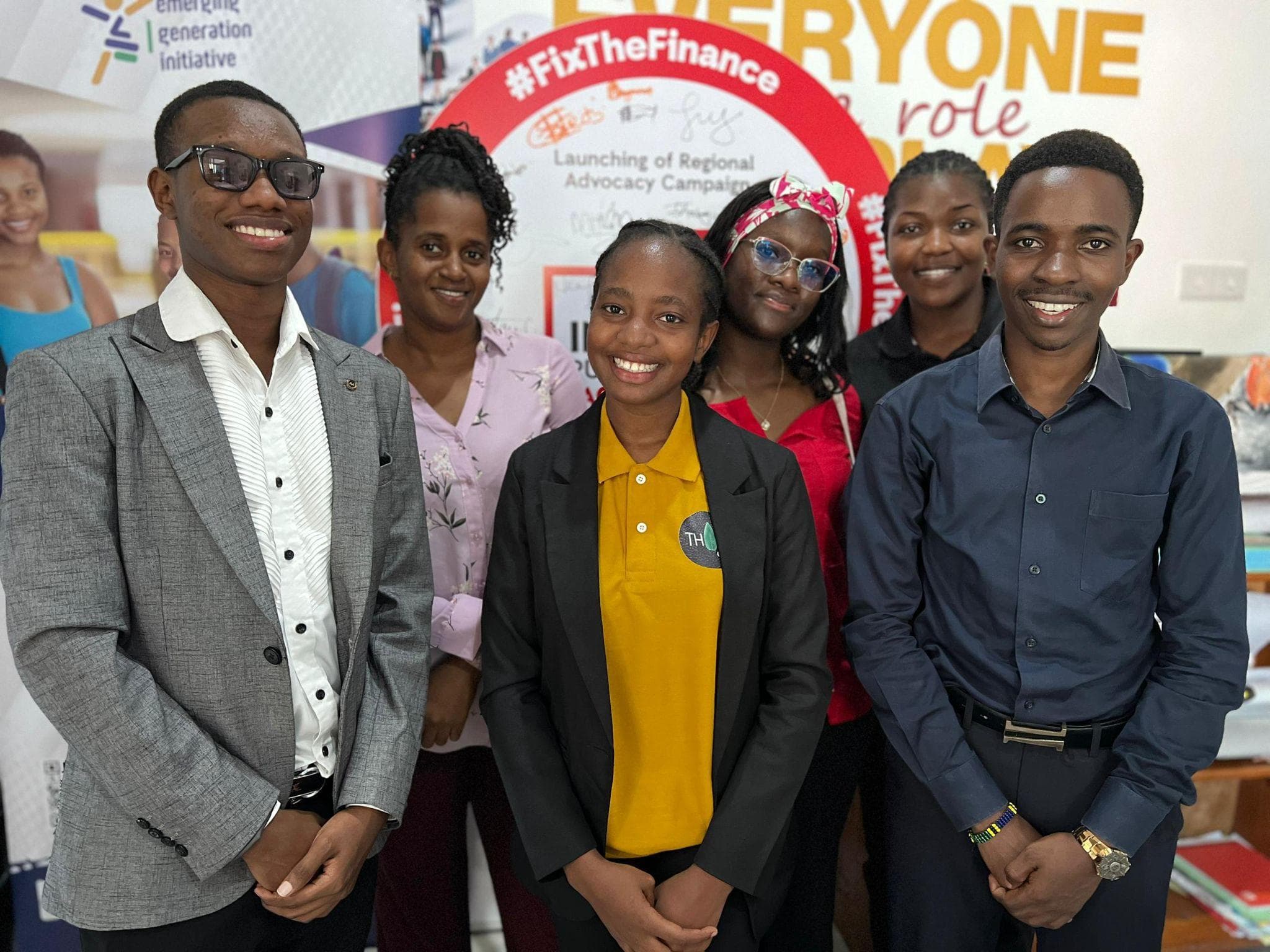 Young participants posing together in front of a Global Platforms wall display.