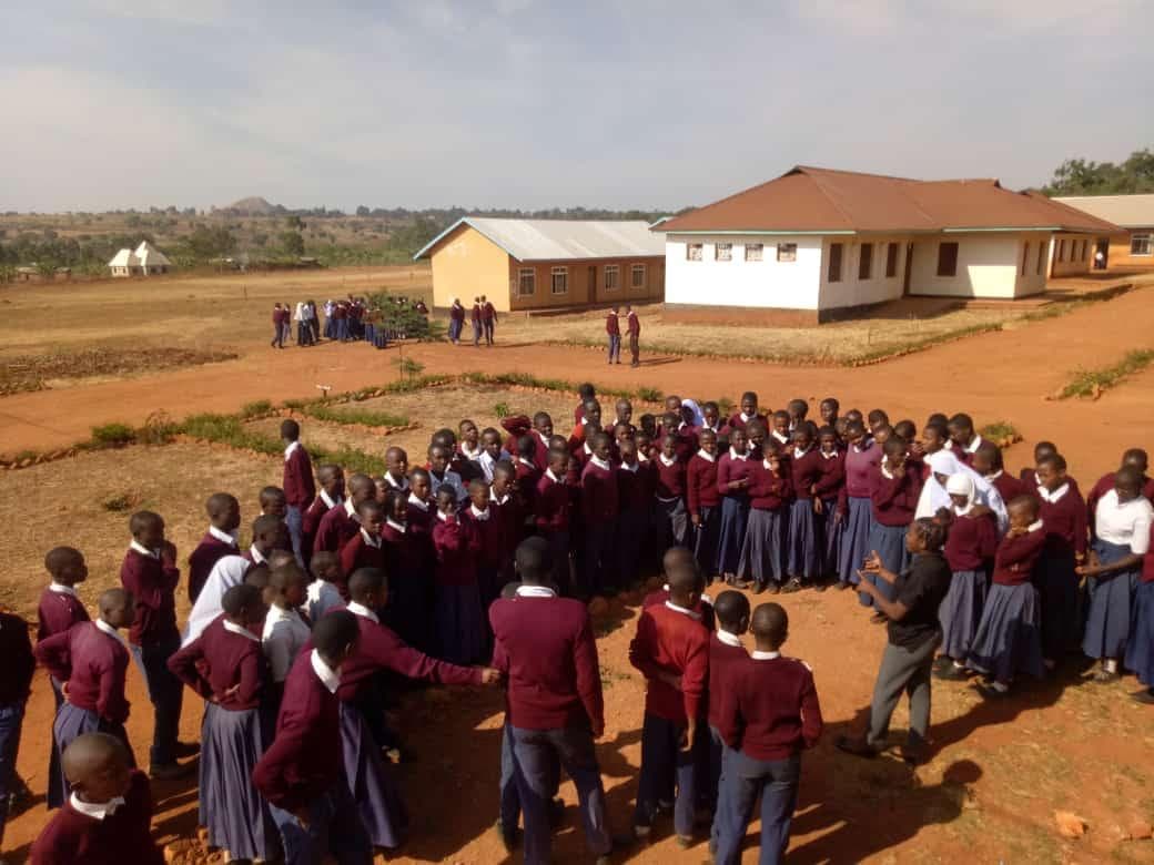 Students gathered outside for an environmental education session at Muhambwe Secondary School.