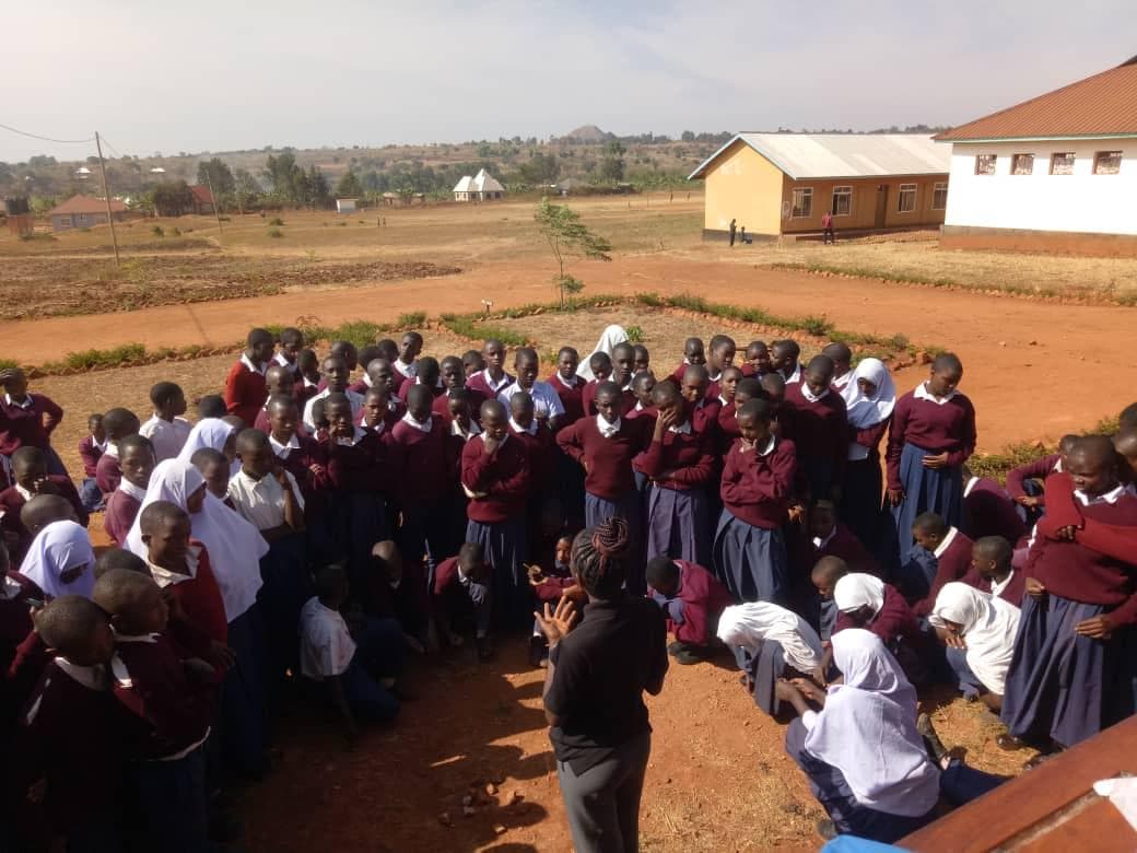 Students gathered in a circle during an outdoor education session.